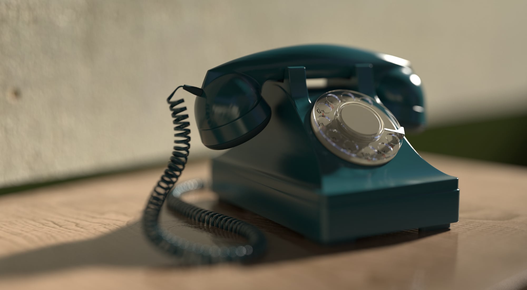 An old-fashioned rotary telephone on a wood surface.